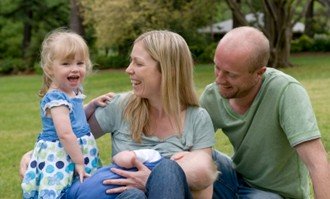 women breastfeeding in public with family